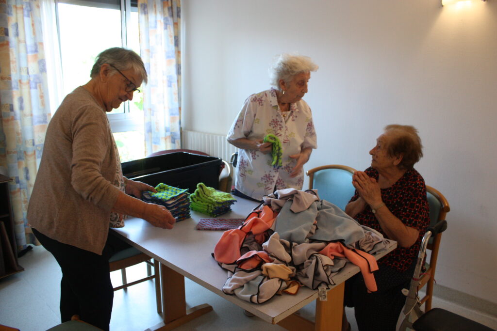 Jacqueline, 89 ans, Juliette, 91 ans, et Arlette, 83 ans, plient les lavettes du ménage © Récit en Série - Isabelle Desprez.