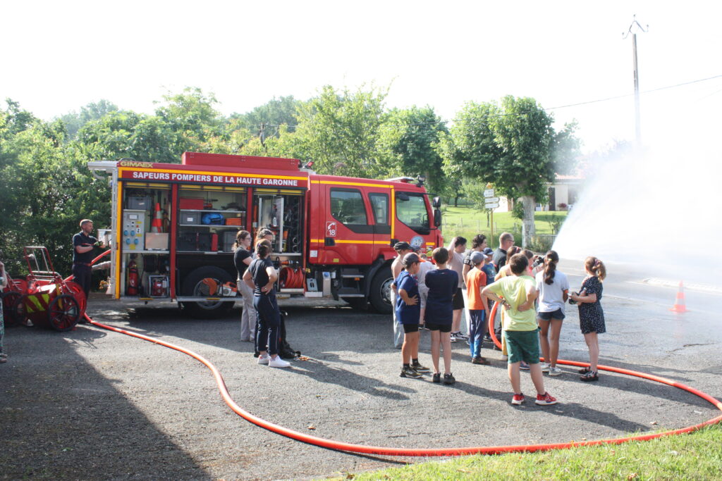 Un sapeur 2e classe fait tester aux jeunes la puissance d’une lance à incendie © Récit en Série - Isabelle Desprez
